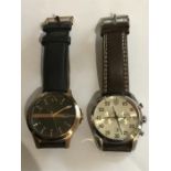 A Ferrari 0830174 D 50 Watch and an Armani Exchange watch.