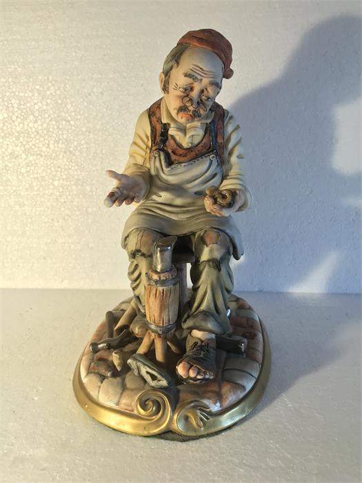 A Capodimonte figure of a cobbler - 25cm high.