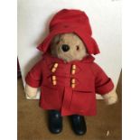 A Gabrielle Designs Paddington Bear soft toy, in red hat, red duffel coat, blue Dunlop Wellington