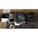 A selection of Tech equipment, headphones, Led dancing speaker, cameras and a webcam.