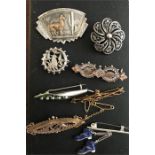Eight various 9ct gold and silver brooches