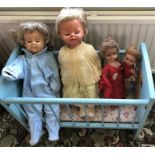 Vintage child’s cot and 4 dolls
