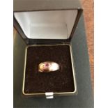 A 19thC 9ct gold ring set with seed pearls and ruby, size Q