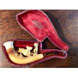 Cased meerschaum pipe of two dogs, with amber stem