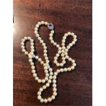 Cultured pearl necklace with seed pearl and amethyst clasp