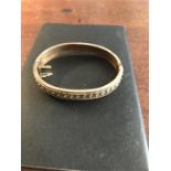 A 9ct gold hinged bangle 10.7gms