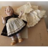 Bisque porcelain doll with hat and clothing