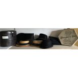 A selection of vintage hats and two hat boxes incldsuing two top hats, two boaters, one bowler, one