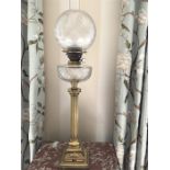 Good quality brass oil lamp with cut glass reservoir (globe damaged)