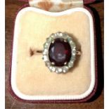 Ladies dress ring garnet? surrounded by white sapphires?