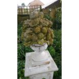 Reconstituted stone urn with fruit on pillar