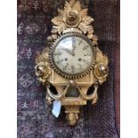 Carved and gilded chiming wall clock