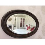 Oval mahogany bevelled wall mirror