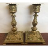 A pair of brass candlesticks C1870.