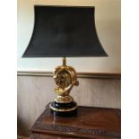 A brass horses head table lamp