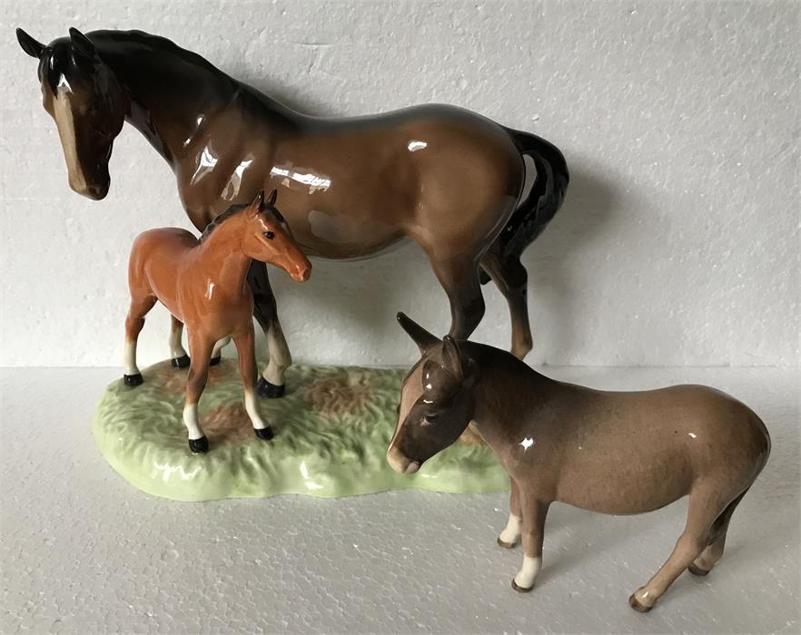 Two Beswick figures of a horse and foal and donkey.