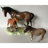 Two Beswick figures of a horse and foal and donkey.