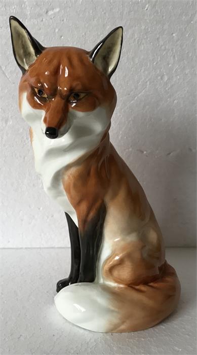 A Royal Worcester figure of a seated fox.