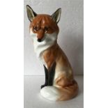 A Royal Worcester figure of a seated fox.