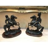 Two spelter horse figures on wooden stands