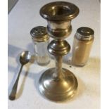 Four items of silver including candle stick, spoon and silver topped jars