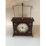 Brass mounted wooden novelty clock with swinging glass ball mechanism