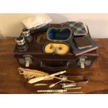 Small leather suitcase and contents inc. silver, penknives etc.