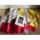 Vintage pageboy outfit together with photograph and yellow child's tailcoat.