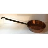 A 19thC heavy duty copper pan with iron handle, 20cms d.