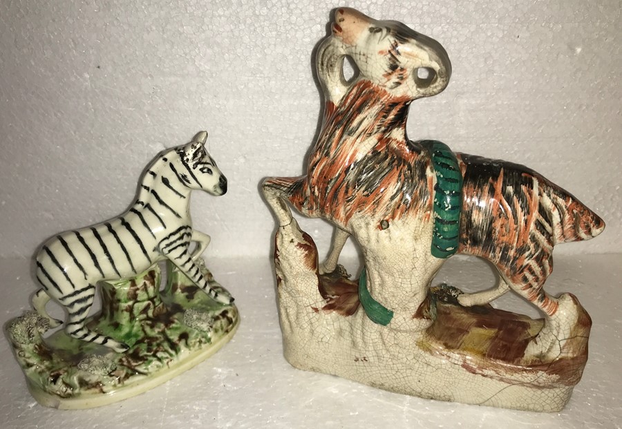 Two Staffordshire figures, goat being eaten by a snake and Parr and Kent 1920's Zebra, both a/f.