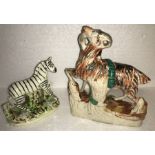 Two Staffordshire figures, goat being eaten by a snake and Parr and Kent 1920's Zebra, both a/f.