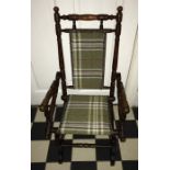 A child's American rocking armchair, well covered in tartan fabric. - 70cms h