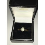 Moonstone ladies dress ring set in yellow metal, size s.