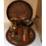 A quantity of metalware to include 2 copper trays, pestle and mortar and Benares ware, chalice