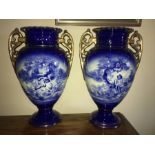 A pair of 19thC blue and white vases depicting cherubs, slight repair to one top. - 39cms h