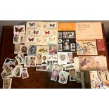 A large collection of cigarette cards, some in books.