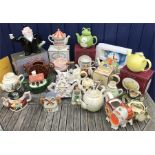 A quantity of novelty teapots including Kiln Cottage Pottery, Bob Hersey and some boxed Sadler.