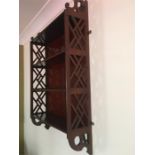 A mahogany wall hanging display shelf