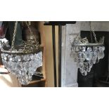 A pair of glass and gilt hanging light fittings with spare drops. 41cms drop.