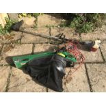A strimmer and electric garden vacuum with leaf shredder