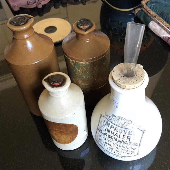 Three stoneware ink jars and an inhaler