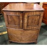 A BOW FRONTED CABINET, two door cabinet over a single deep drawer beneath, with cross banded