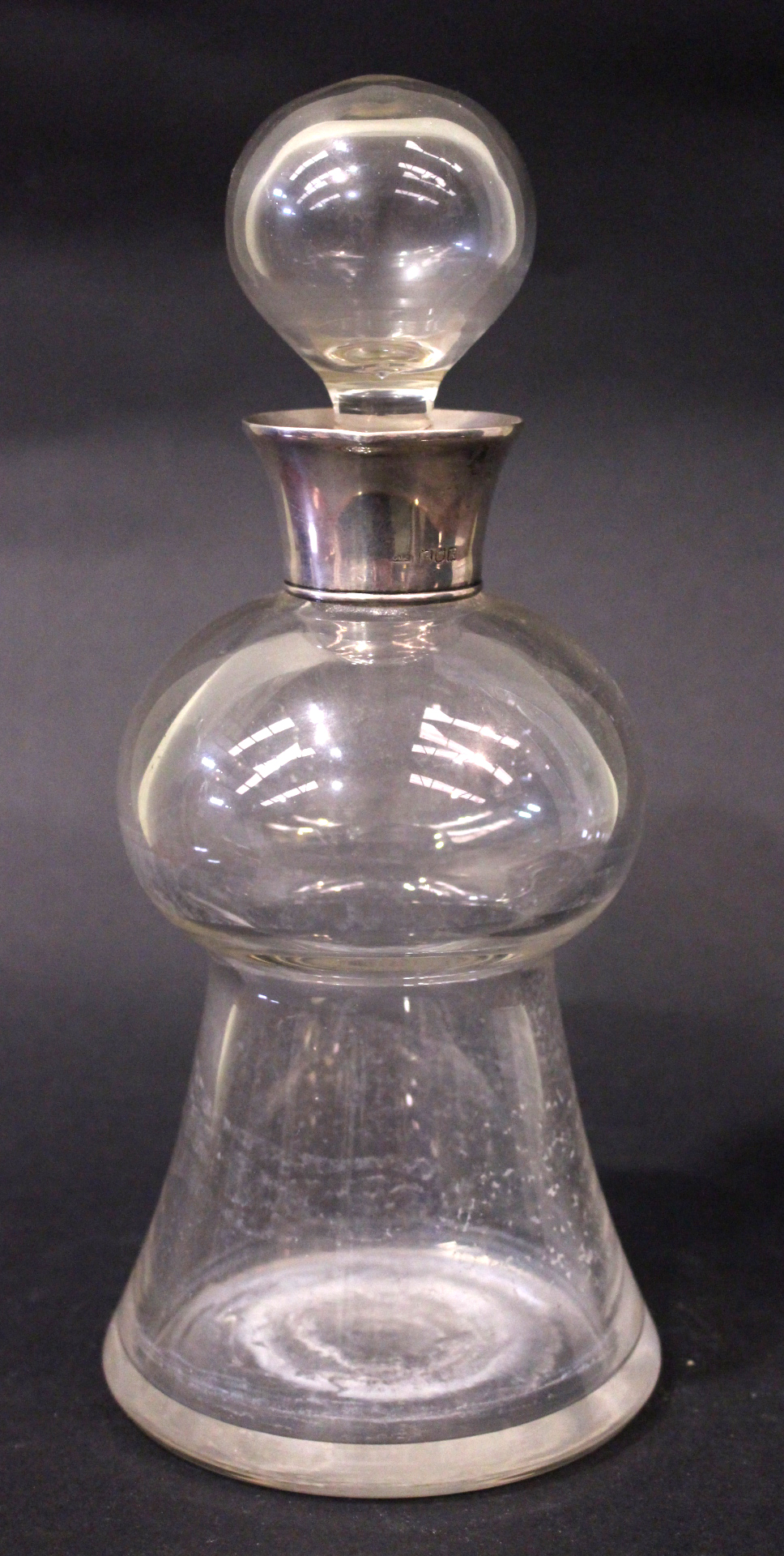 A SILVER COLLARED GLASS DECANTER, with stopper, London, standard sterling silver date 1905/06,