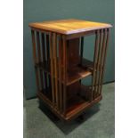 A MAHOGANY REVOLVING BOOKCASE, with slated shelves, two tier, 18" x 19" x 35" approx