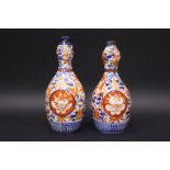 A PAIR OF 19TH CENTURY IMARI BUD VASES, gourd form, with floral decoration, (1) 7" tall, (1) 6.75"