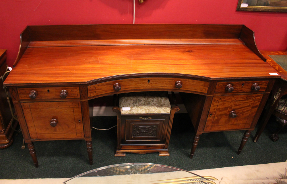 A LARGE SIDE BOARD, decorated with ebonised detail to the front, a single central curved drawer,