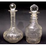 TWO GLASS DECANTERS, (1) With triple ring neck, broad fluted shoulders, vertical cuts to the