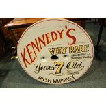 A PAINTED WOODEN WHISKEY SIGN, "Kennedy's Irish Whiskey", large, 32" diameter approx