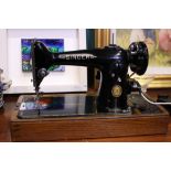 A SINGER SEWING MACHINE, mid century, electric, comes with instruction book, accessories, and in