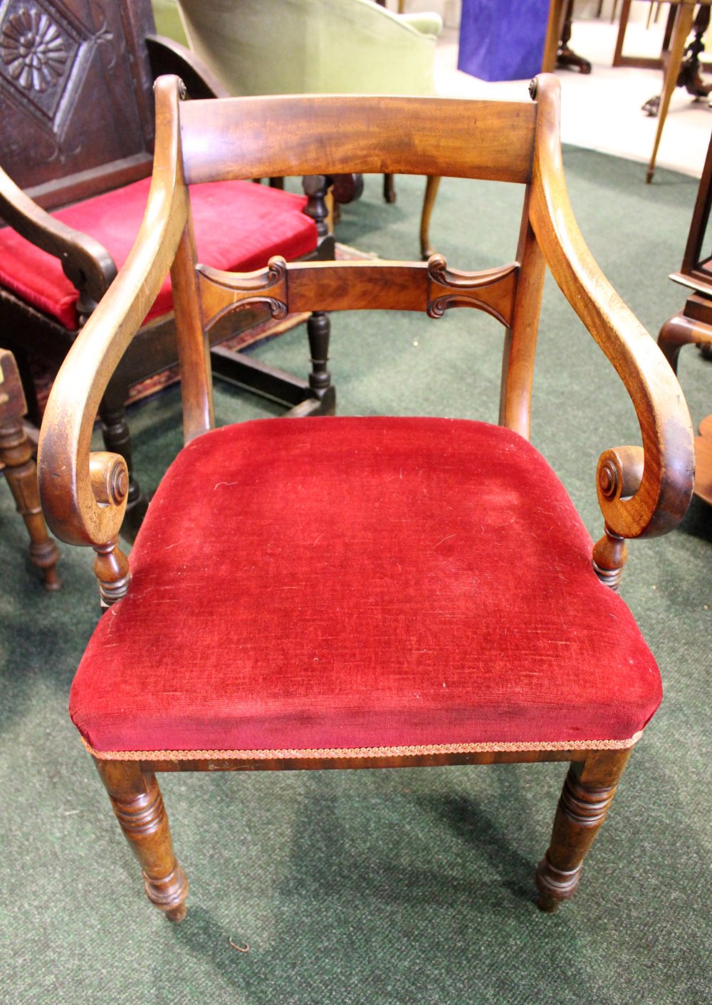 A REGENCY STYLE CARVER/ARMCHAIR, with scroll shaped armrests, tipped with scroll to shoulder